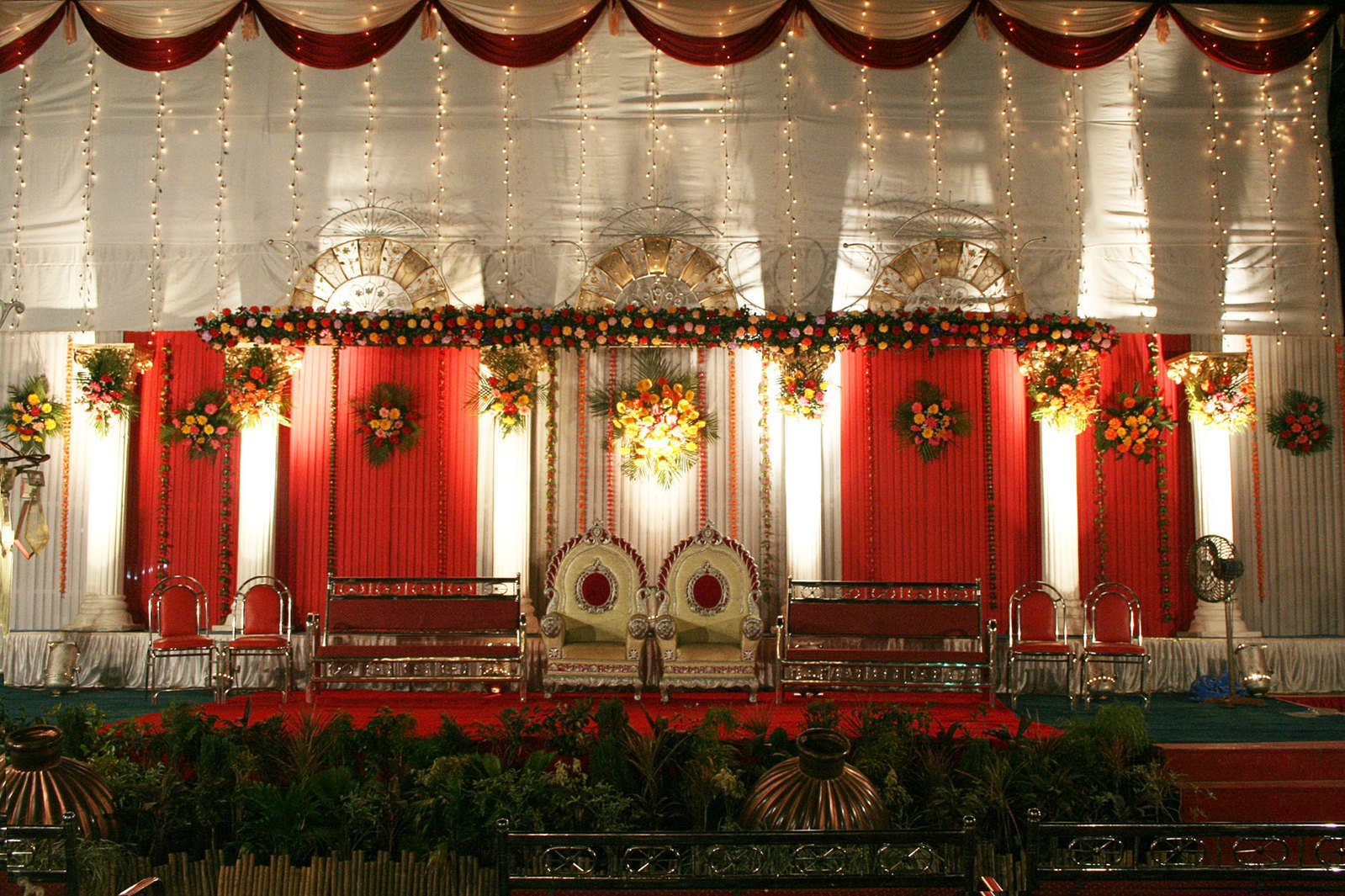 a christmas themed stage setting with red and white ds, floral decorations, and greenery
