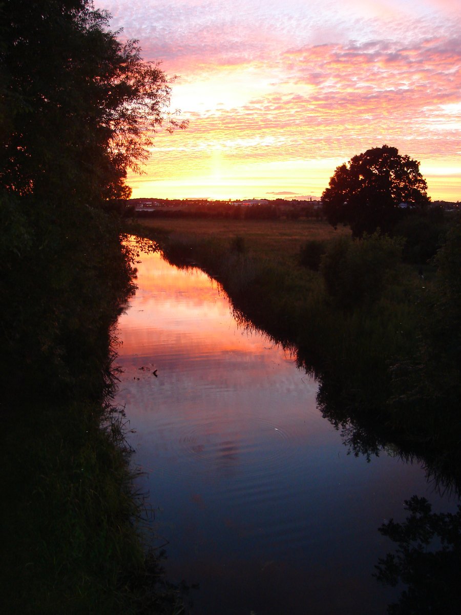 this is a sunset over a creek