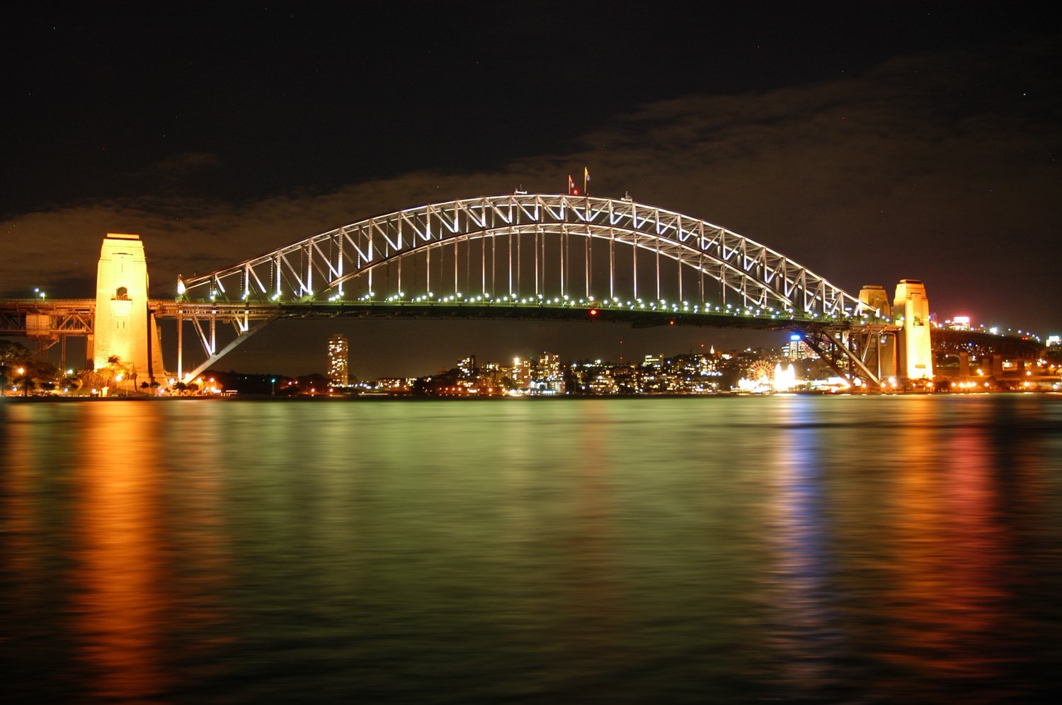 a city view with a large bridge spanning the width of the water