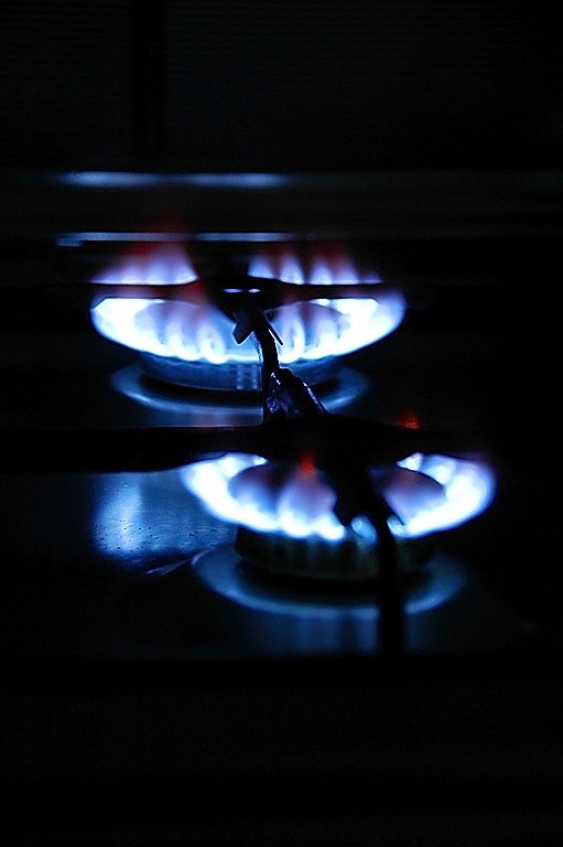 a black and blue picture of flames in a stove