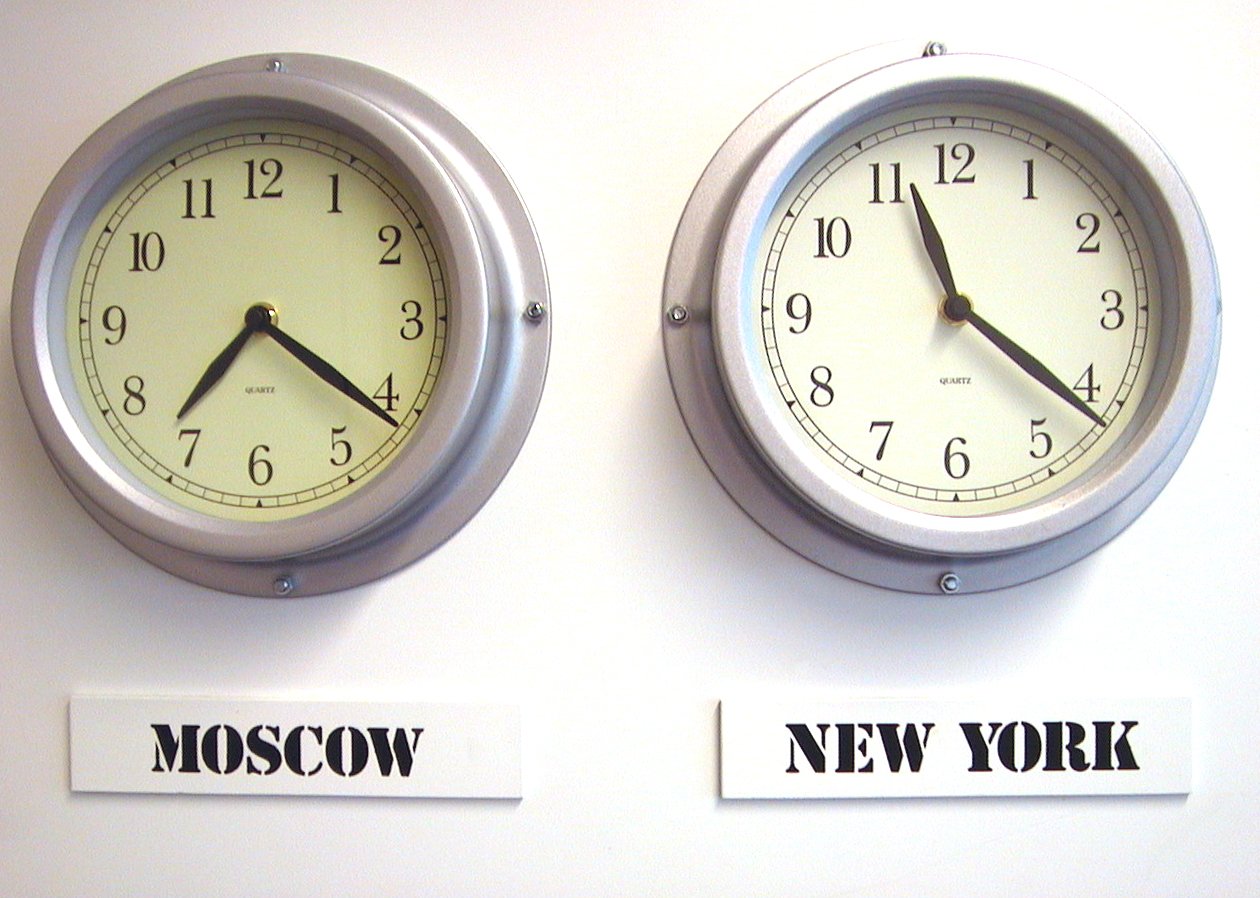 two clocks displaying the times to different cities