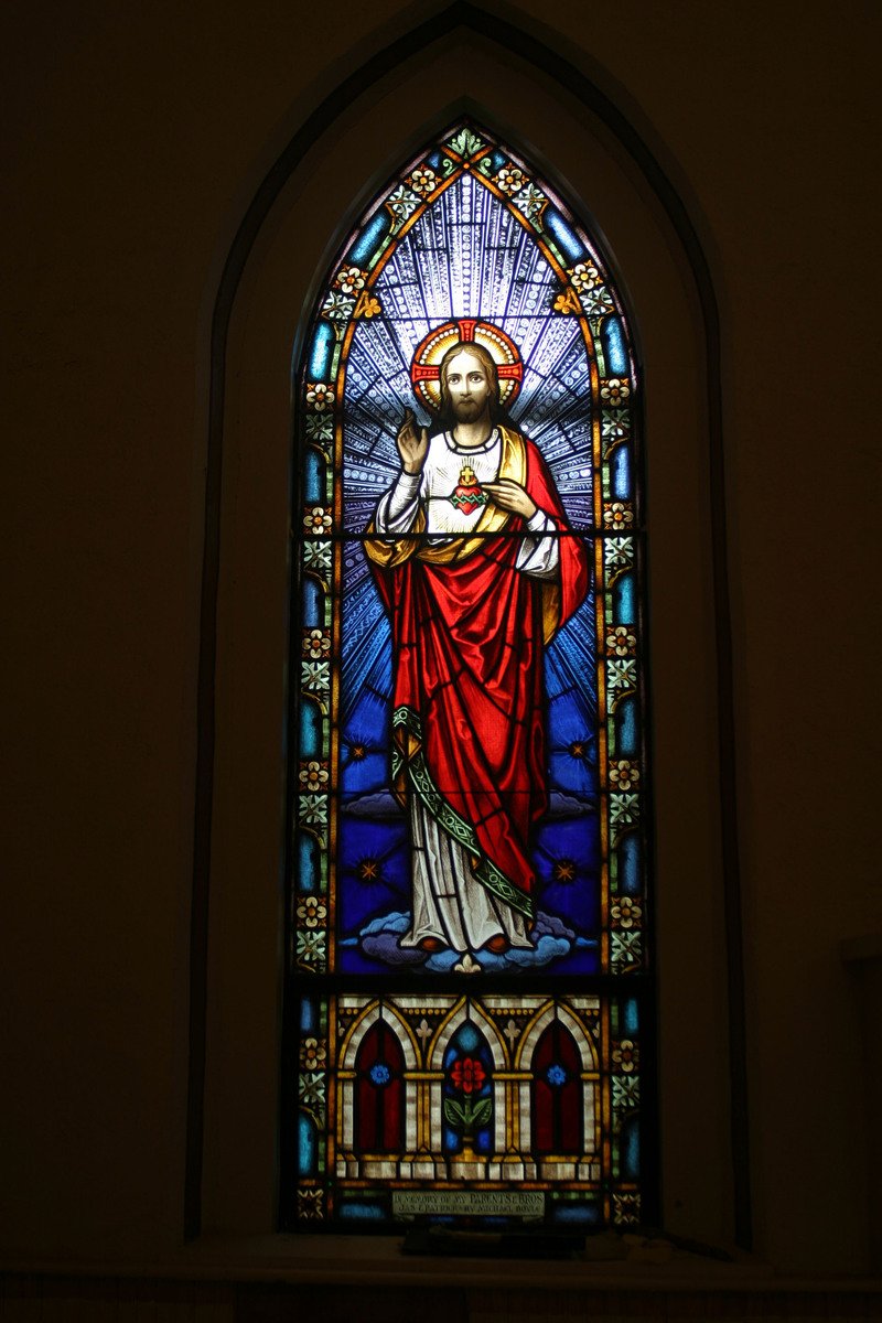 a stained glass window with the image of jesus