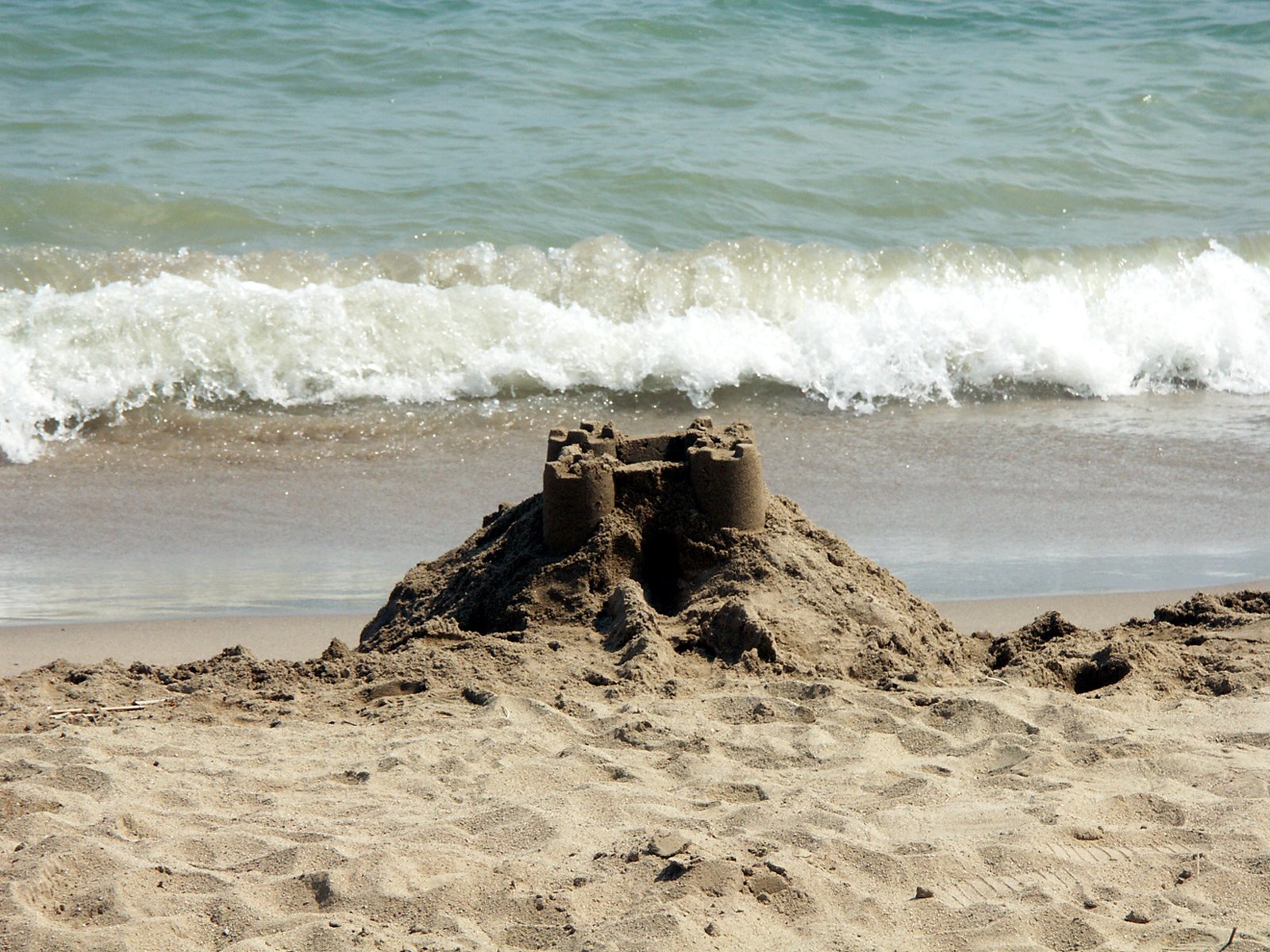 a sand castle in the middle of an ocean