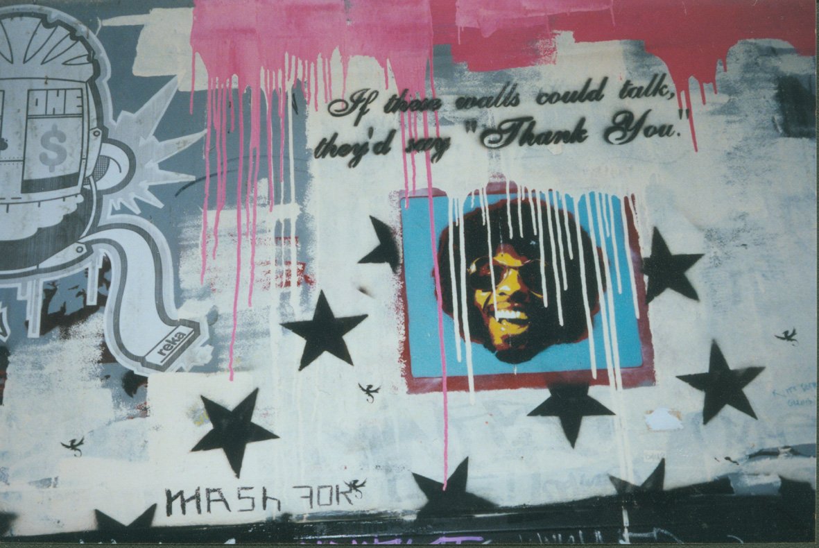 graffiti with stars and the caption of a black man with a mustache