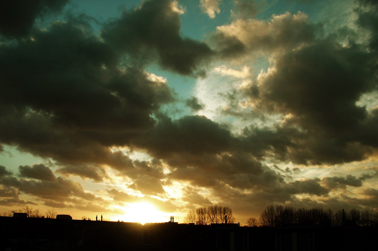 a view of a sunset and some clouds in the distance