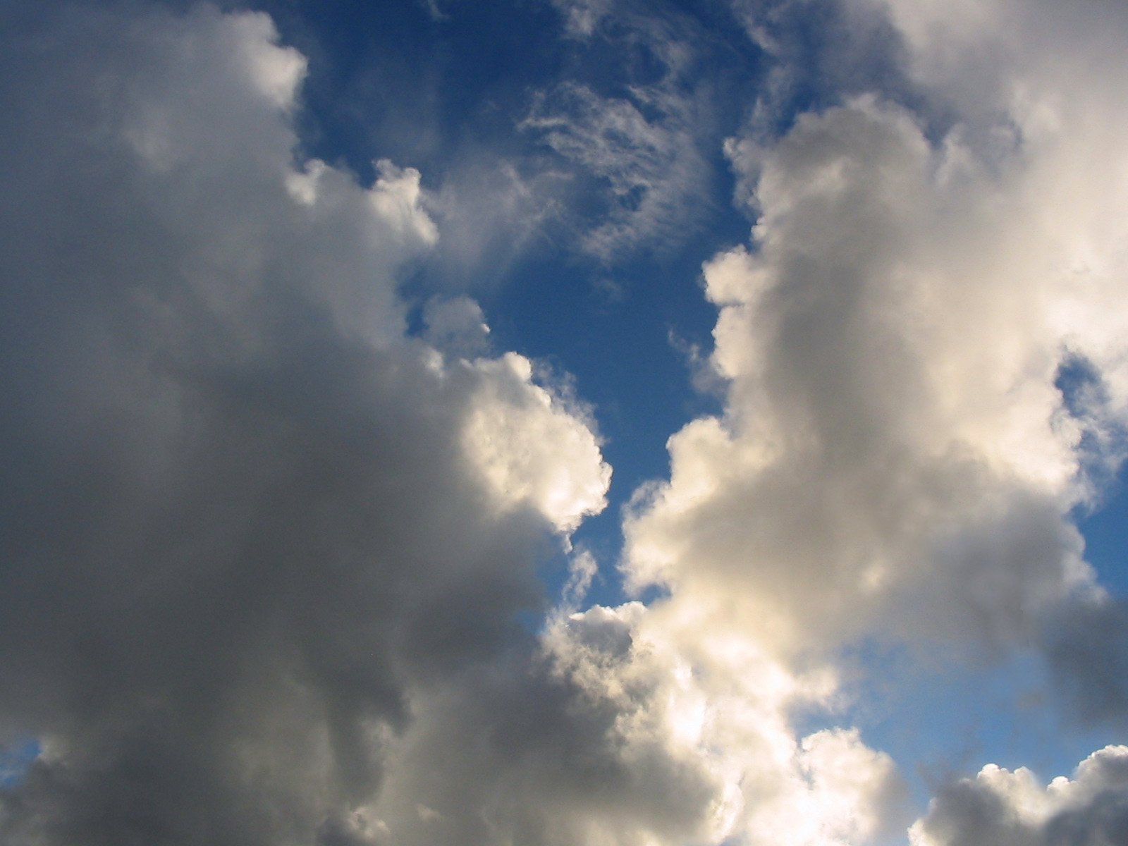 there are clouds in the sky above the clock tower