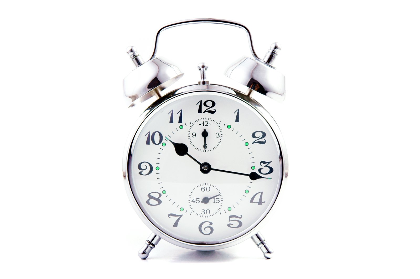 a white analog alarm clock in a round frame