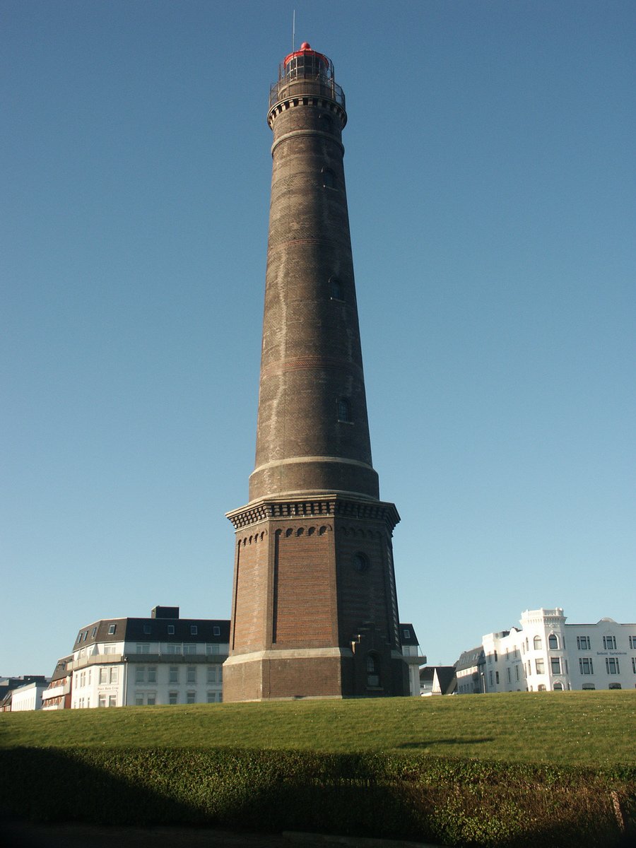 a tall tower standing in front of a city