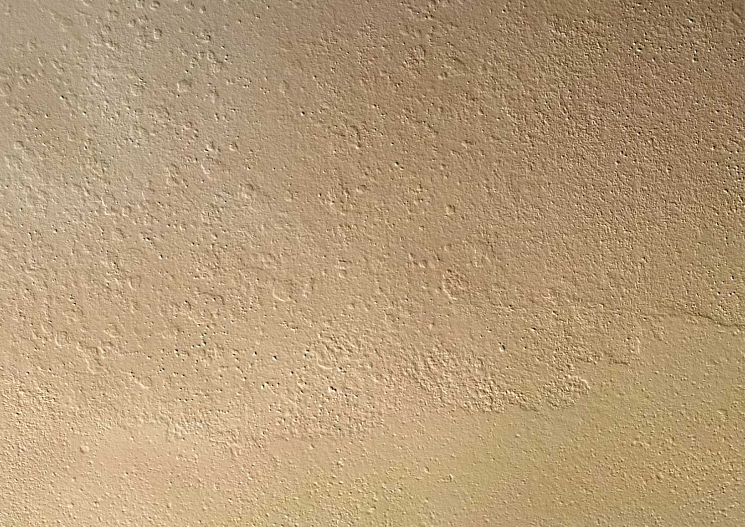 the exterior wall is tan and has a pattern