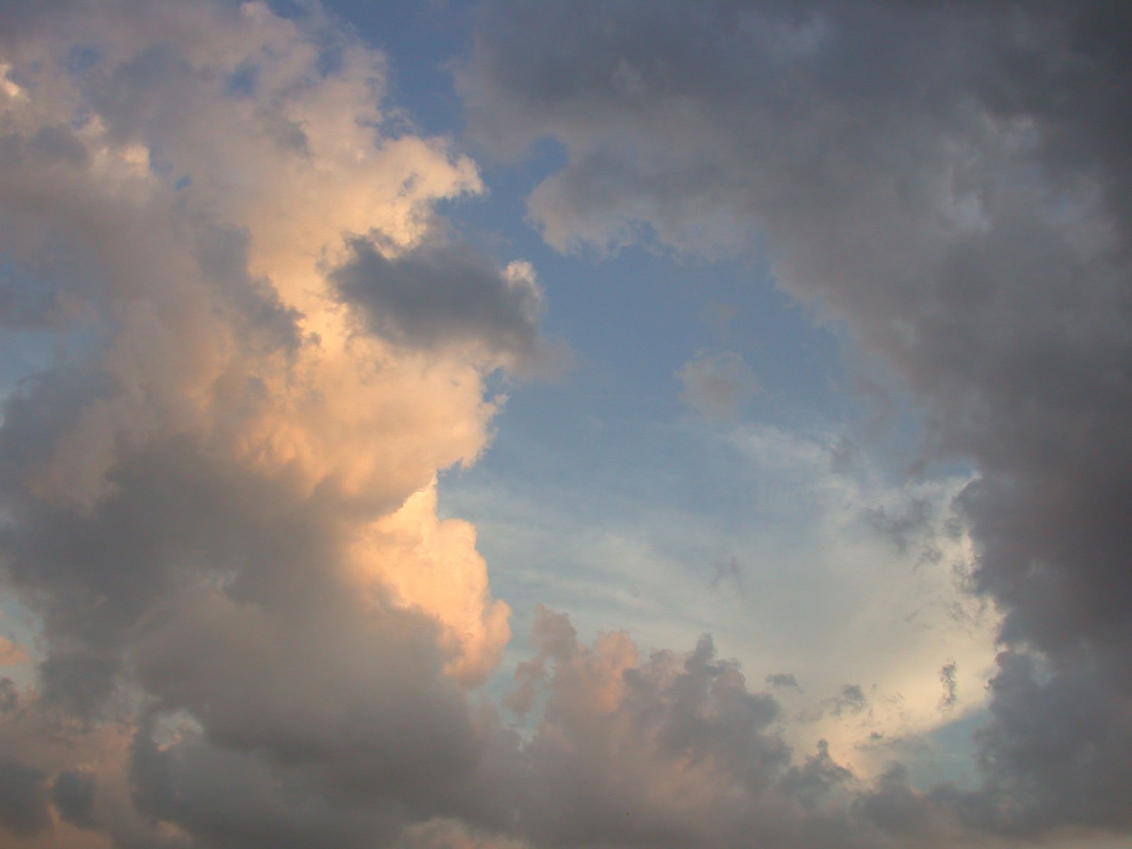 a large cloud has an overcast sky above it