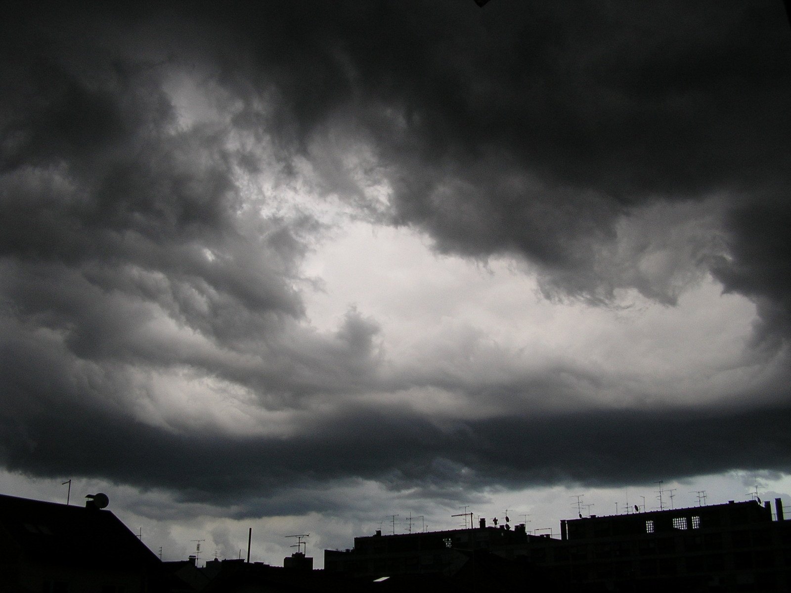 a person flying a kite in the cloudy sky