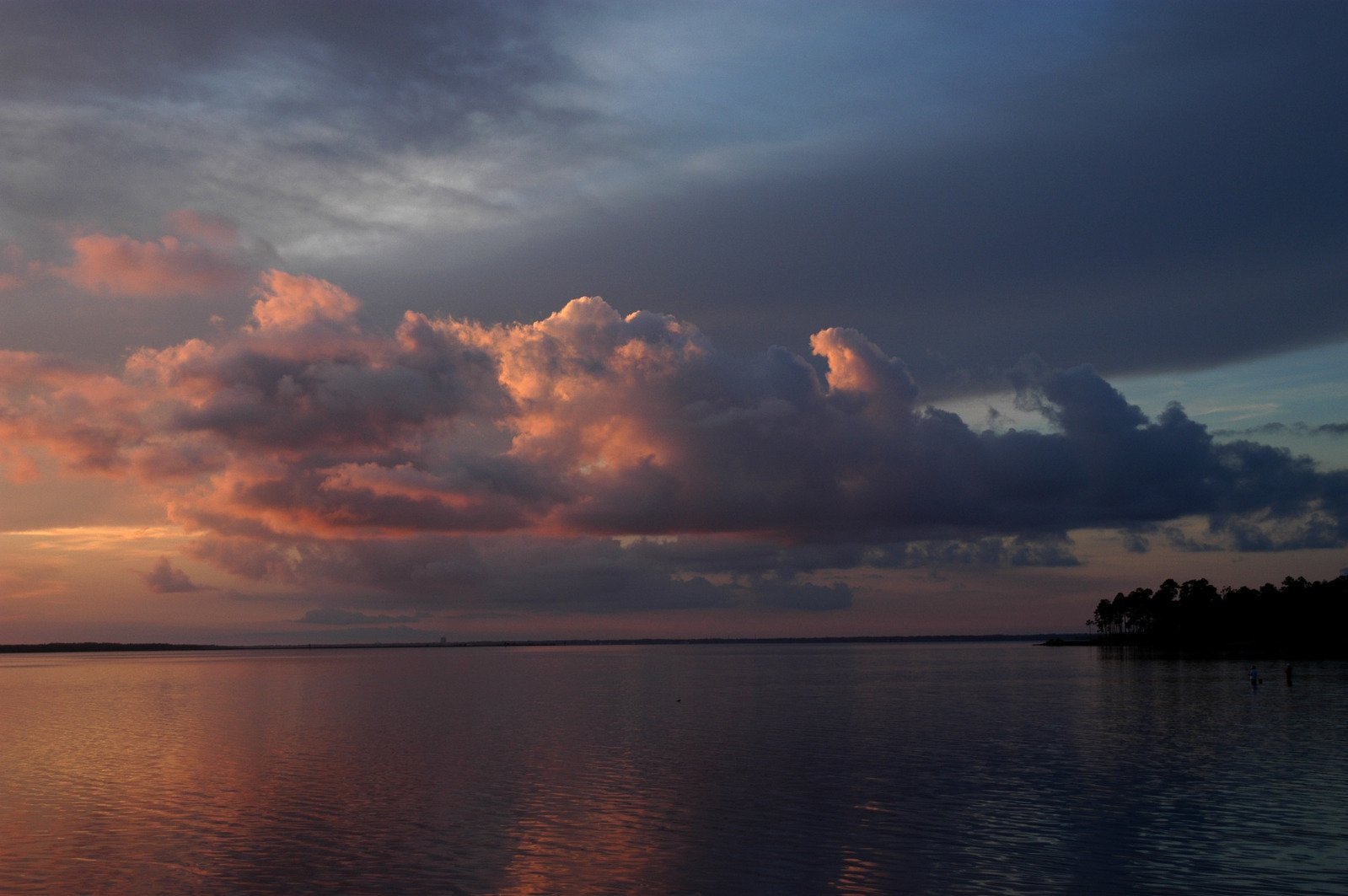 the sun is setting behind some very clouds