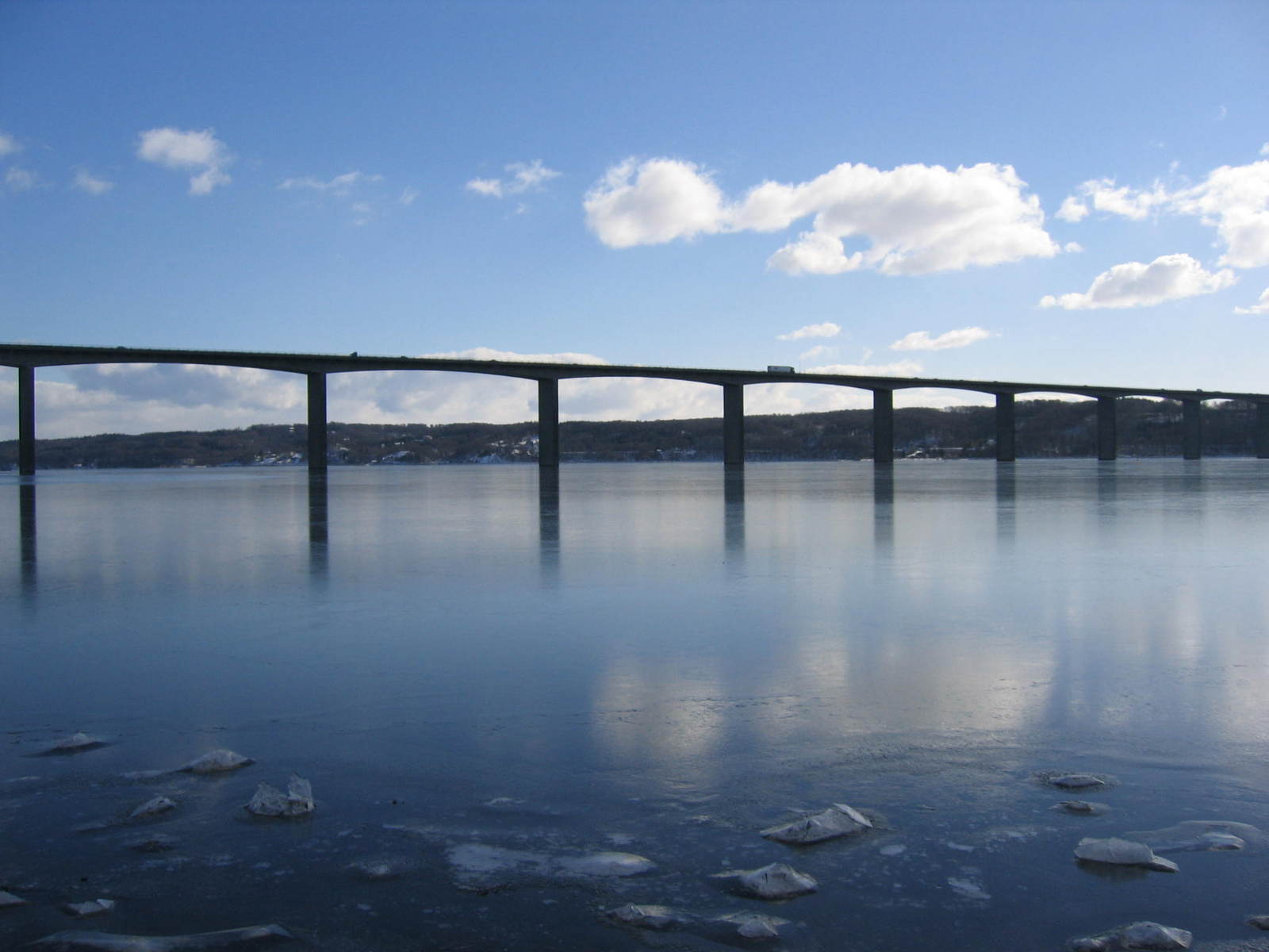 large bridge surrounded by blue skies and snow