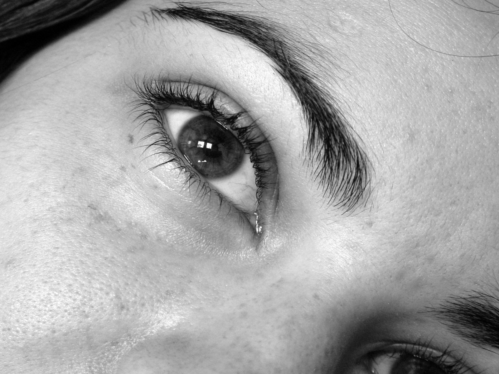 a black and white picture of a womans right eye
