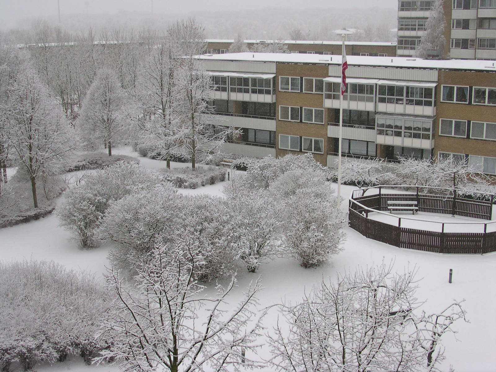 there is a building that has snow on the ground