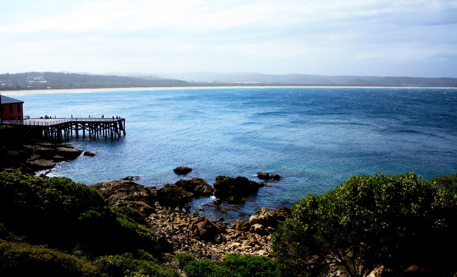 view from above of the water at pier and beach