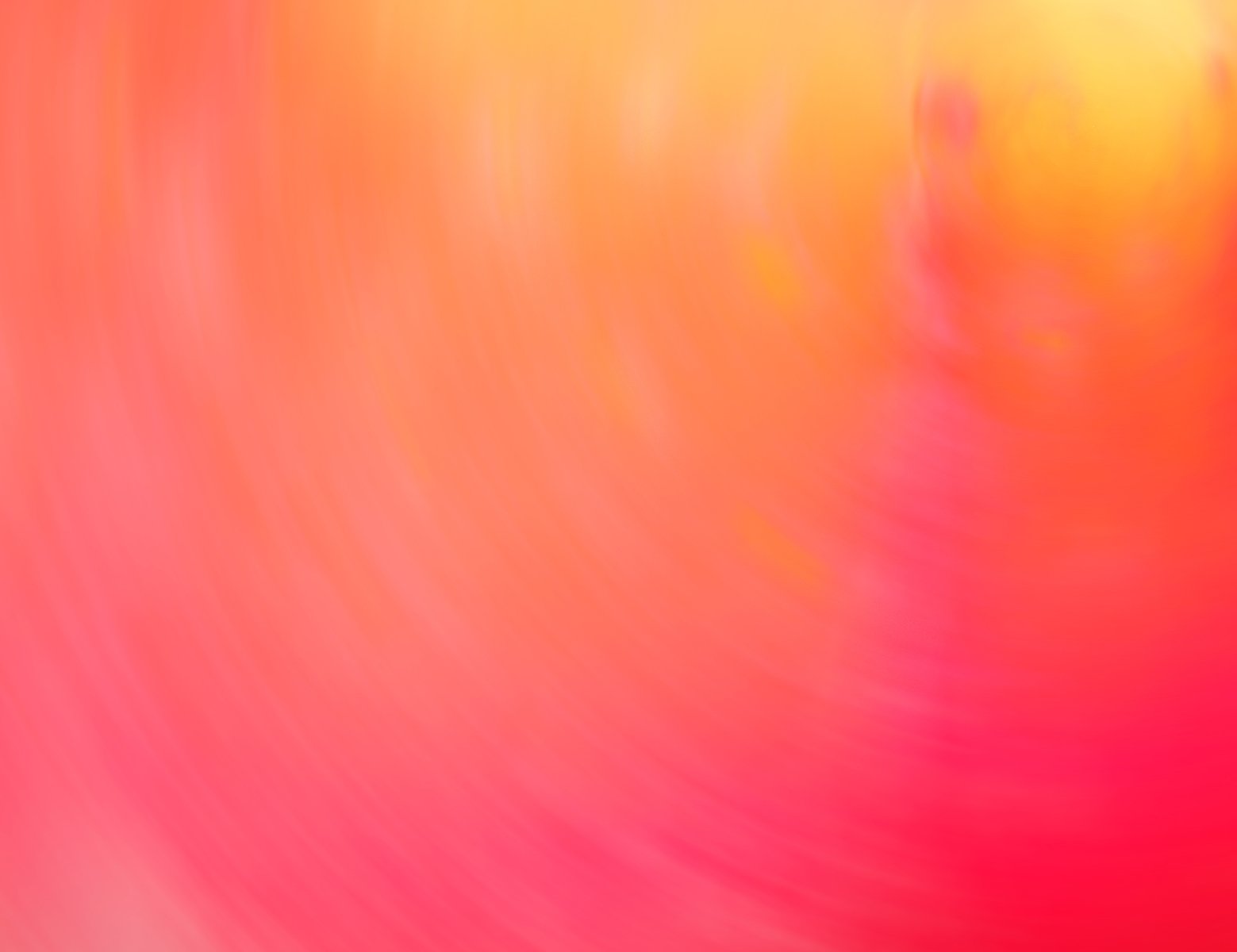 an image of a blurred orange in the middle of a colorful background