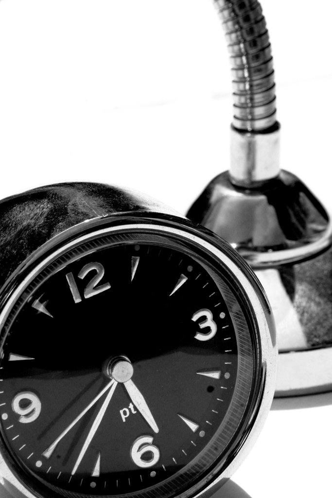a black and white image of an alarm clock and a microphone