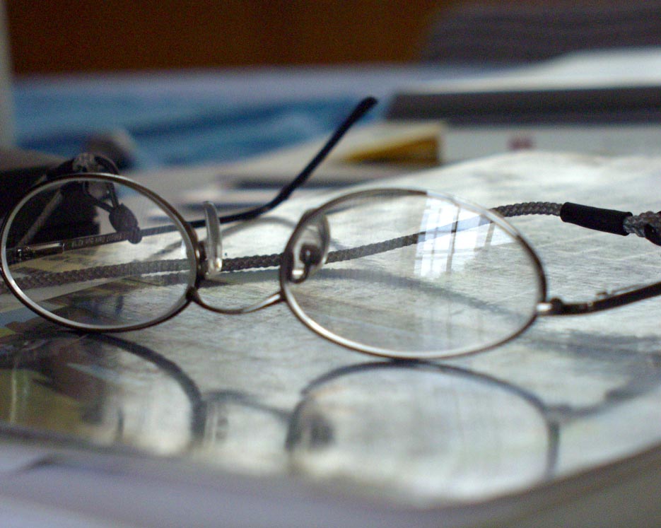 a pair of glasses sitting on top of a desk
