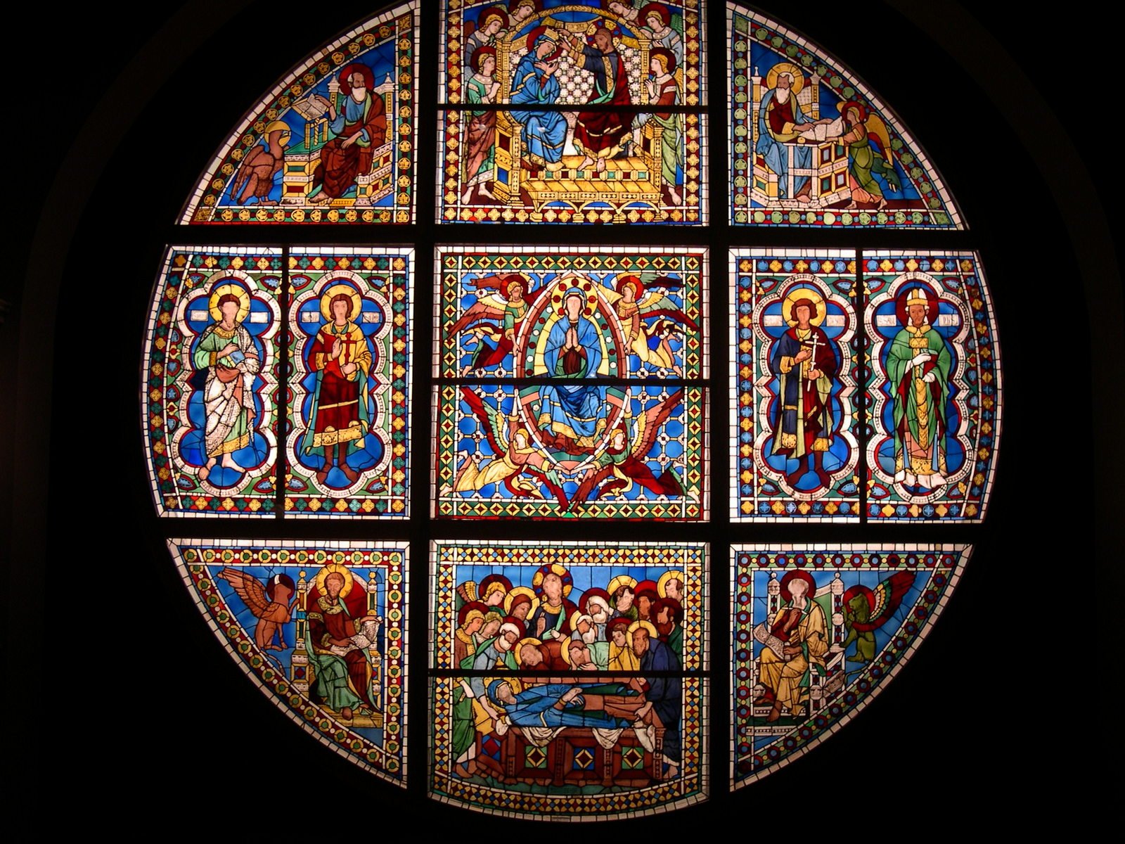 a very elaborate stained glass window in the middle of the room