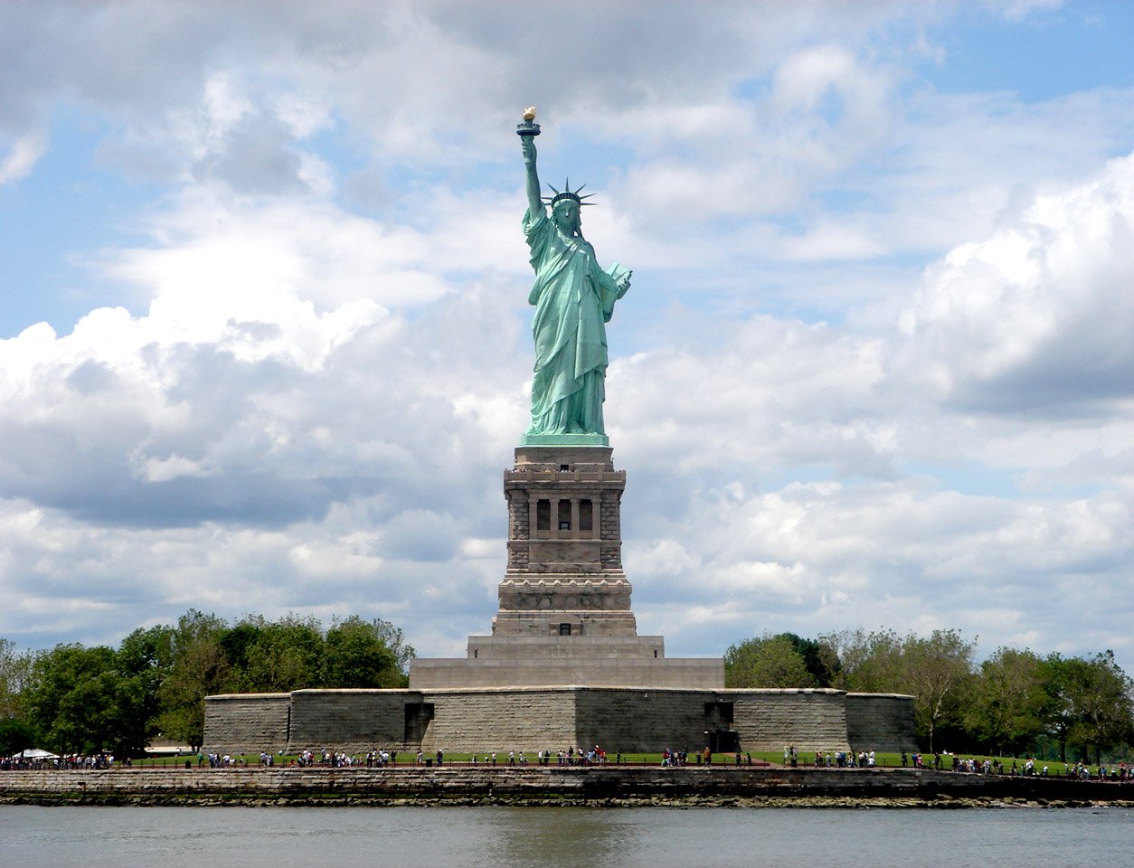 a view of the statue of liberty from across the water