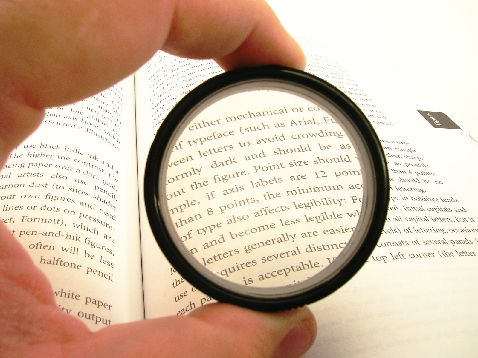 a person with glasses is looking through a magnifying glass