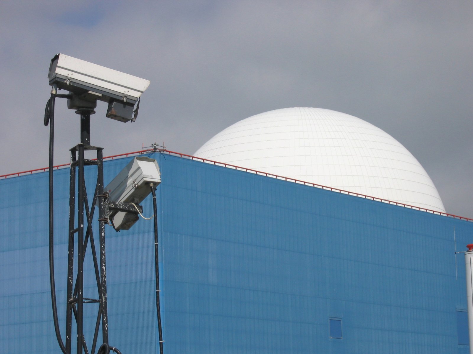 an old television camera and a satellite dish sitting on top of a building