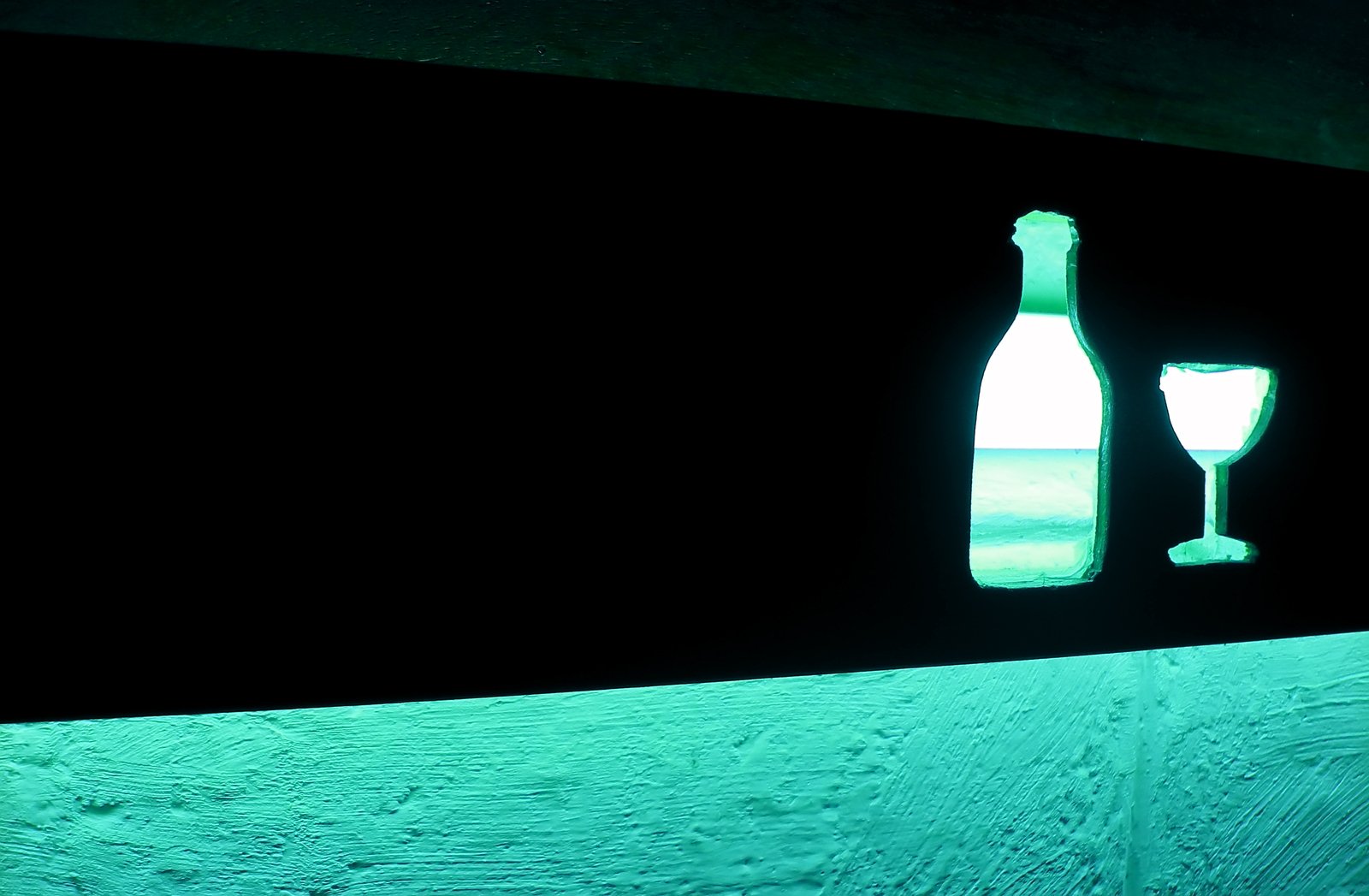 a bottle and glass are sitting on a surface