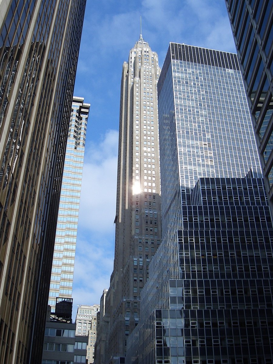 looking up at the top floors of several tall buildings