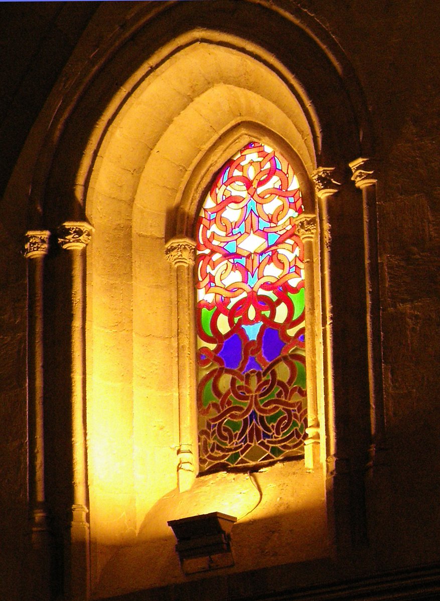 a stained glass window lit up in the dark