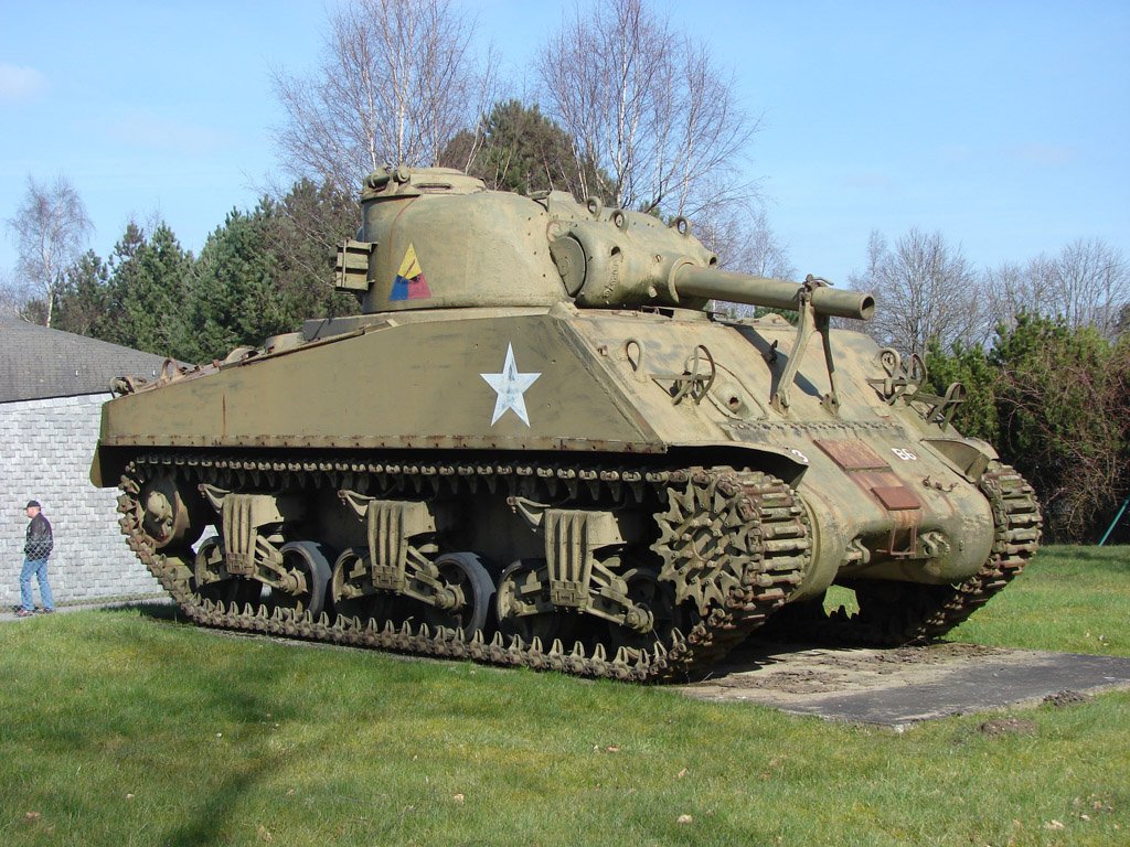 a small army tank is on display outside in the yard