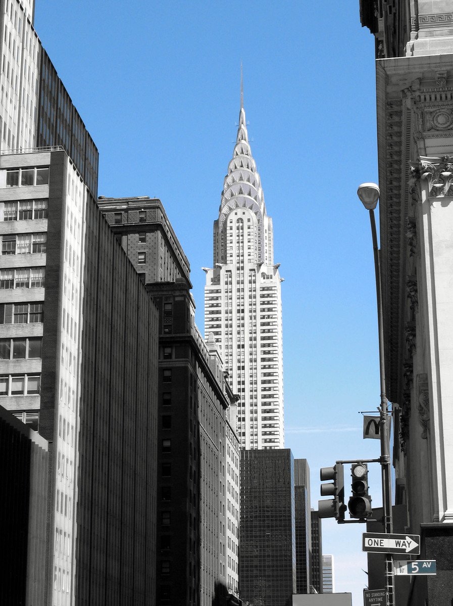 looking up at a tall building from a city street