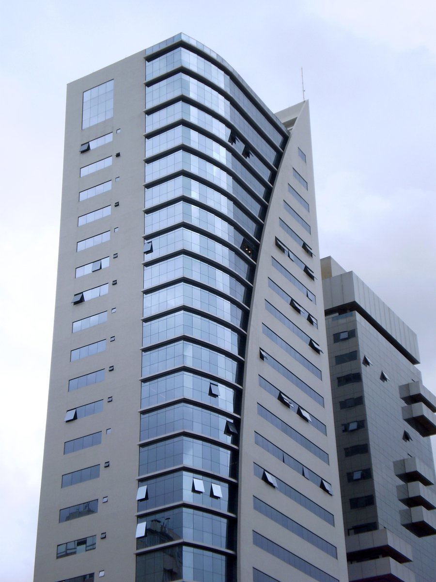an apartment building with the building made from grey stone