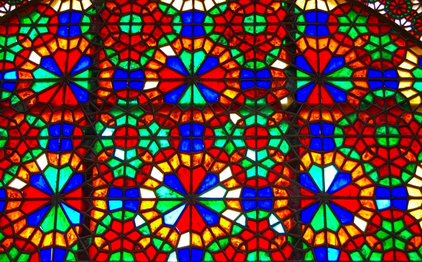 a very colorful stained glass window with circular designs