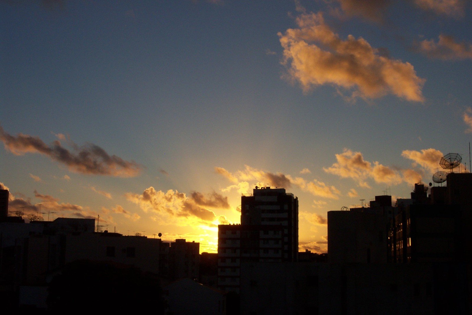 a view of the sunset with building silhouettes