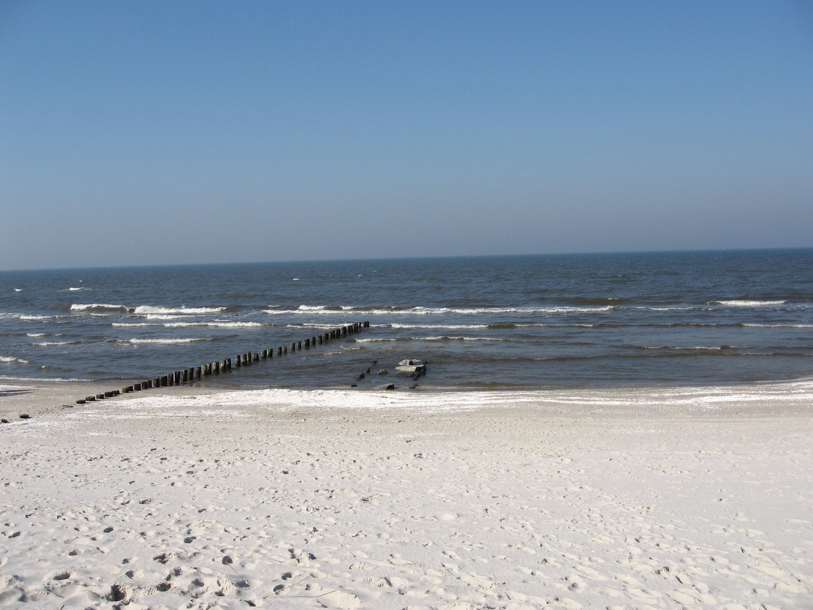 a white sandy beach filled with small waves