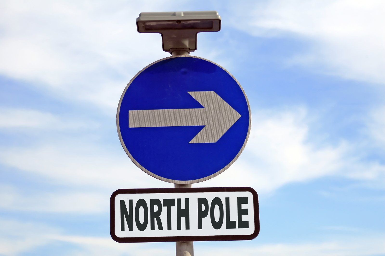 a sign pointing to the right with the word north pole and arrow pointing upward