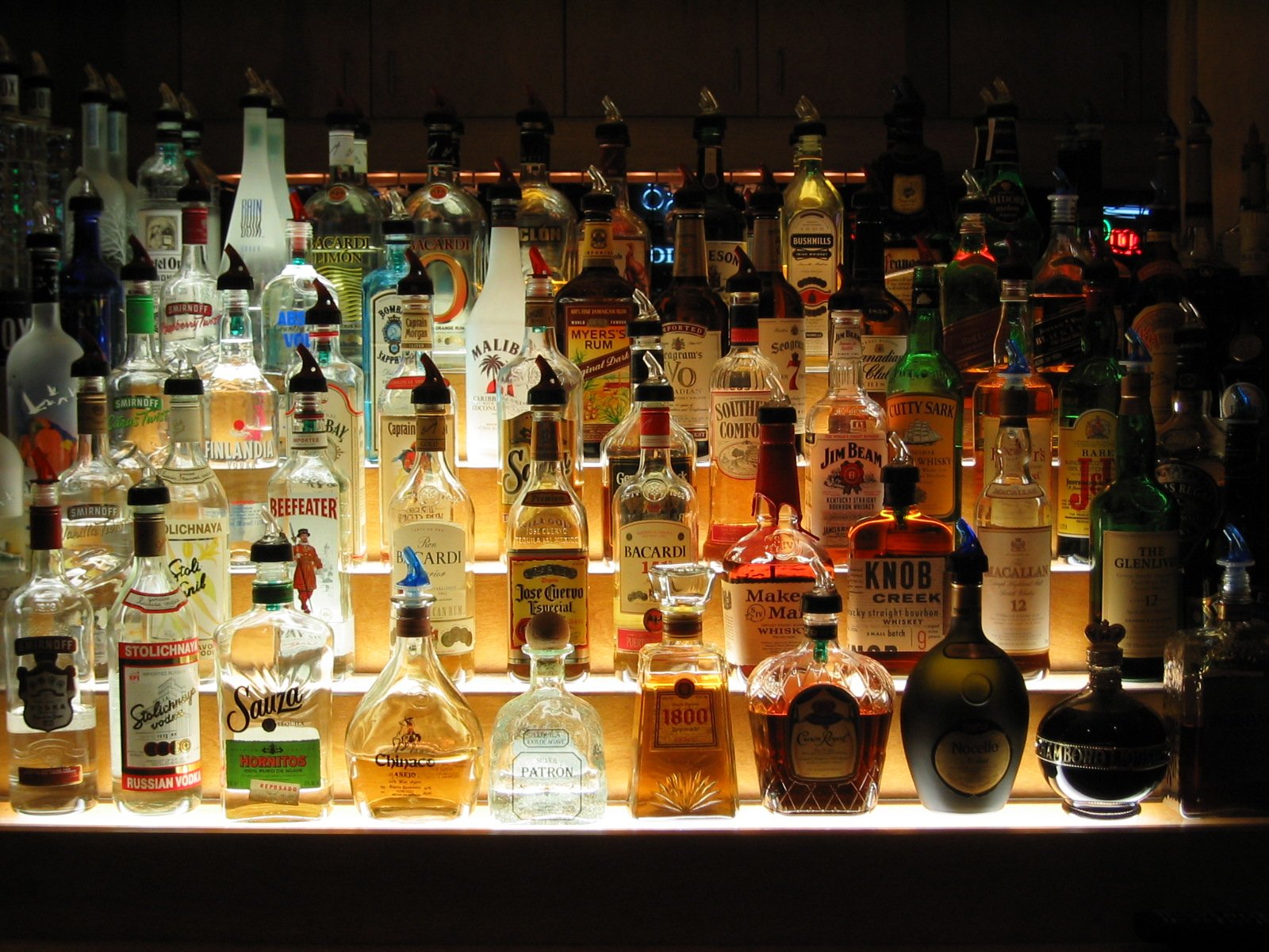 bottles on display behind an illuminated counter