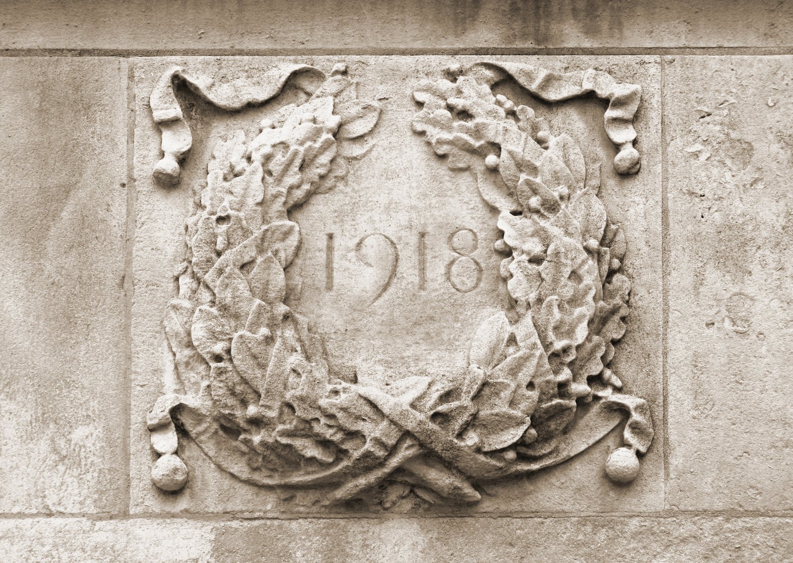 an old brick sign with a wreath on it