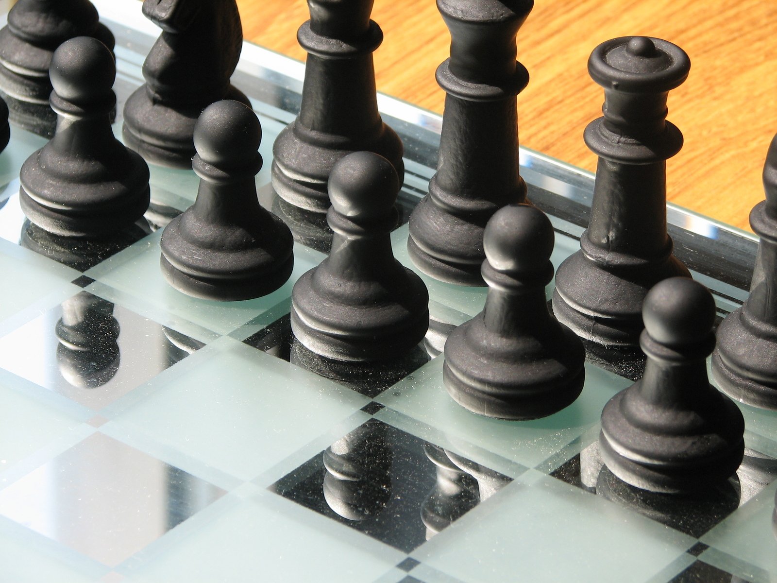a chess board with some black chess pieces