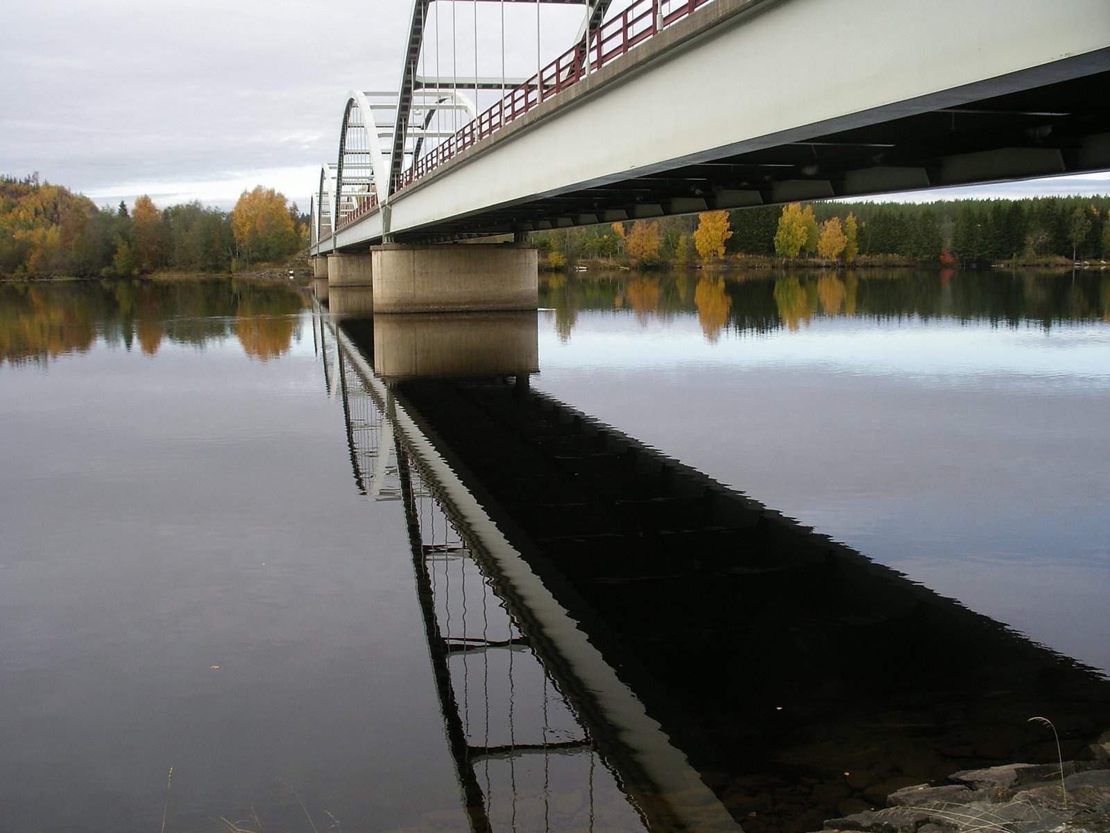 a bridge over the water on a cloudy day