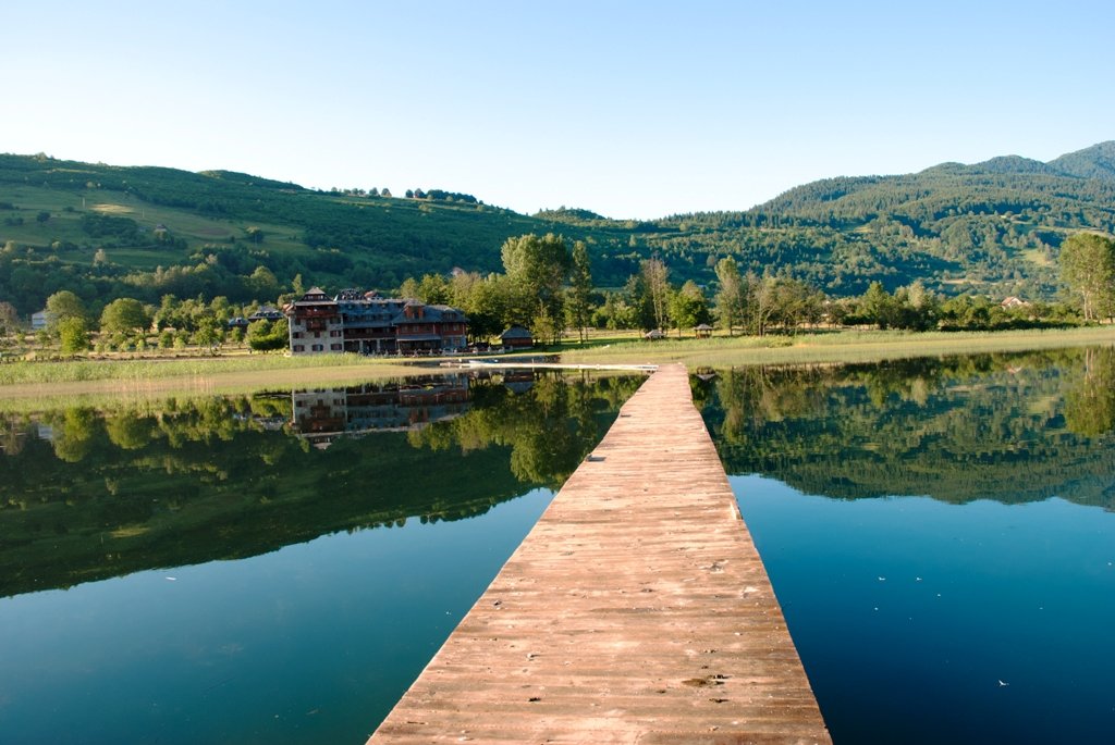 a dock extending into a beautiful mountain lake