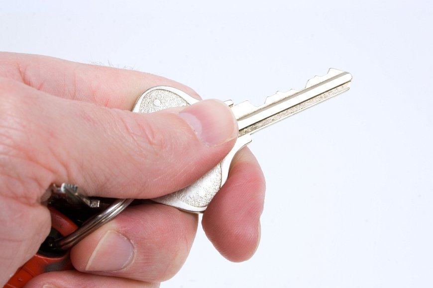 a man holding a pair of scissors in his hand