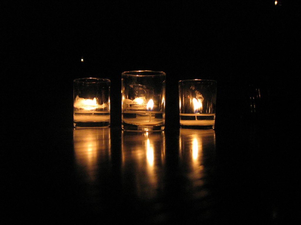 three empty glass bottles are next to each other