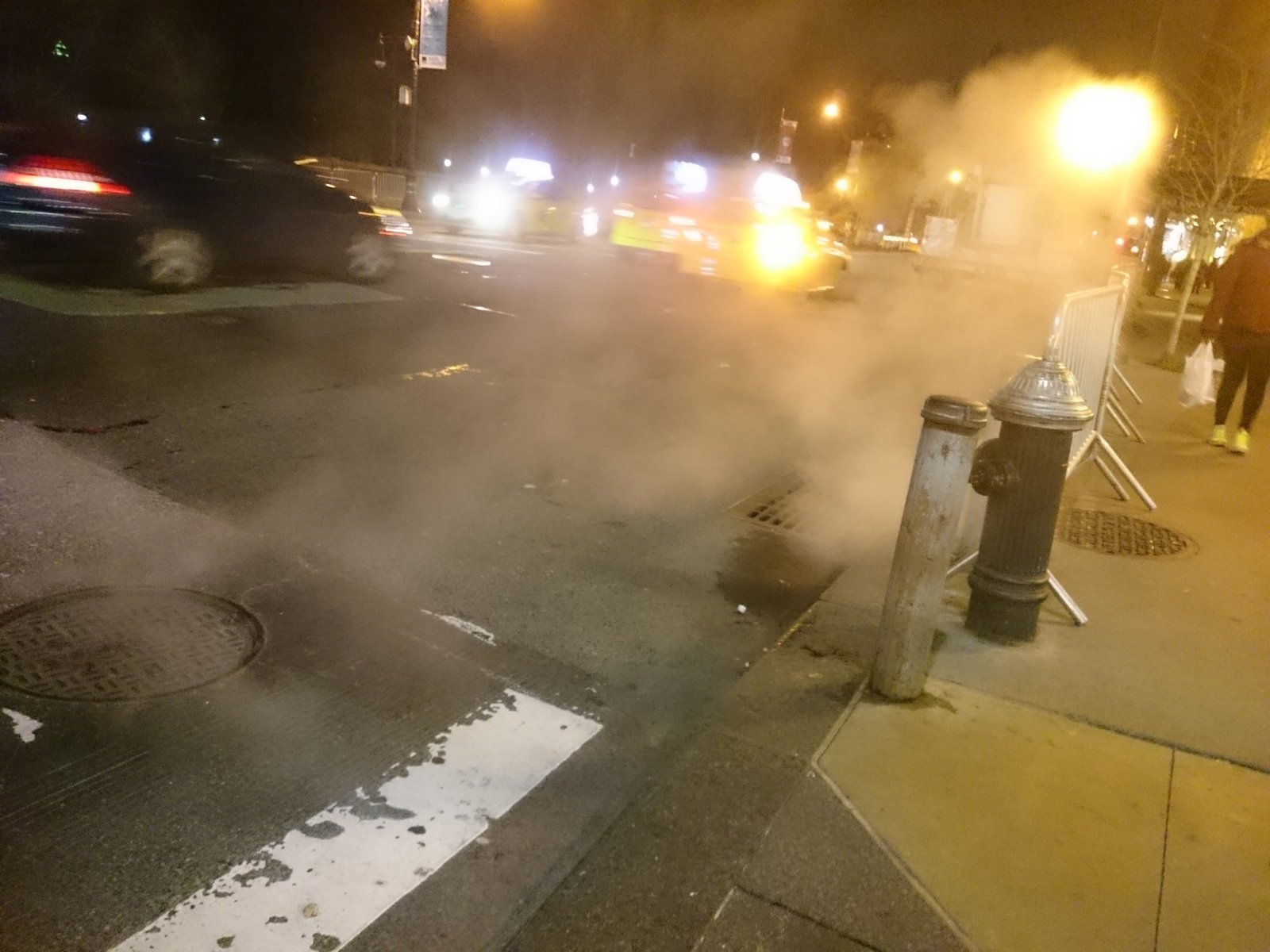 the fire hydrant was emitting out smoke into the street