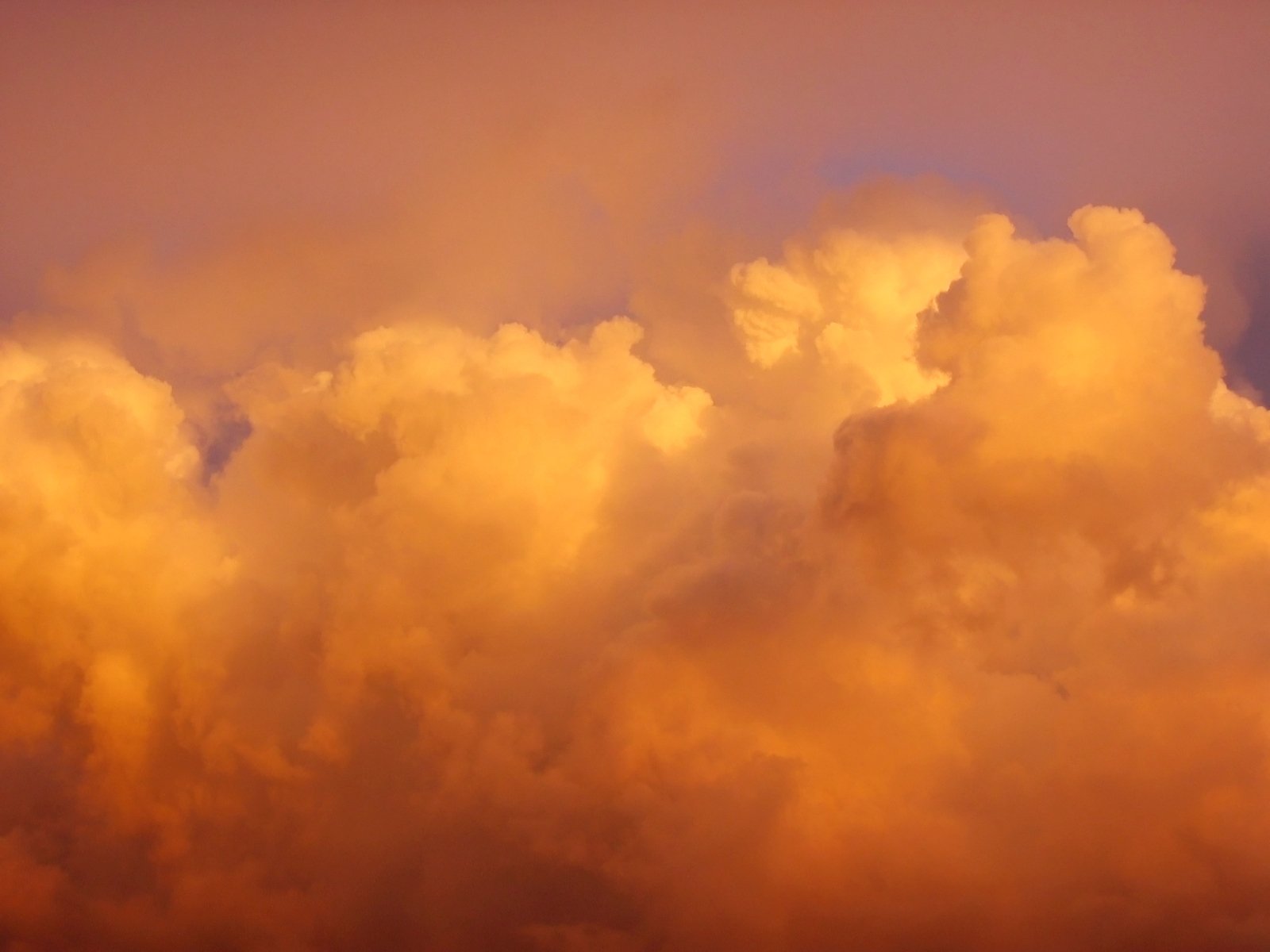an orange cloud that is above the sky