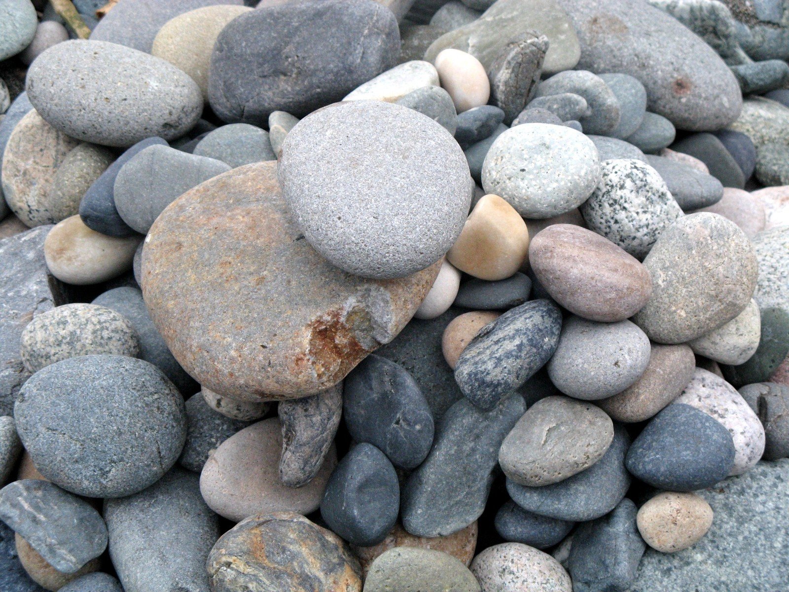 several different rocks are stacked up in a pile