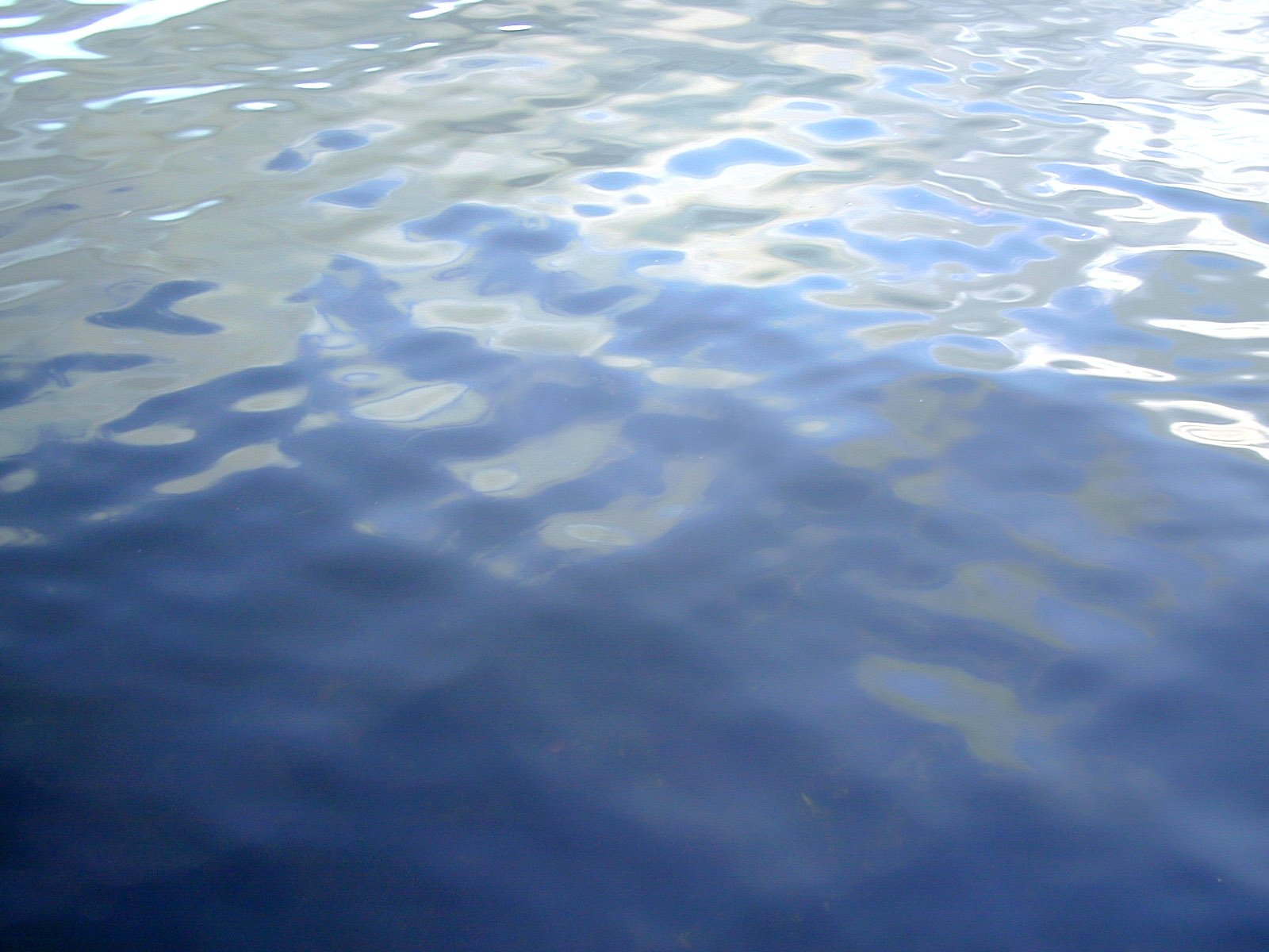 the surface of blue water reflecting small ripples