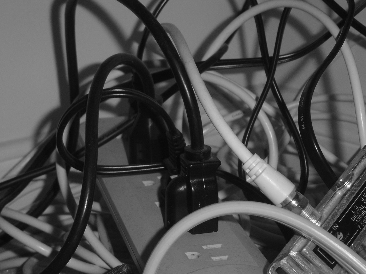 various wires, cords, and plugs are hooked to one another