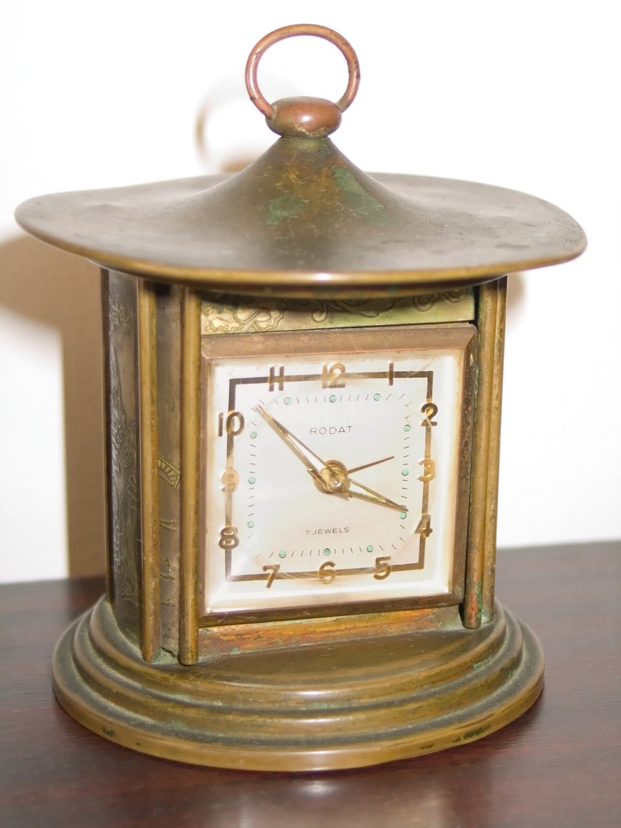 a small clock that has been put on top of a table